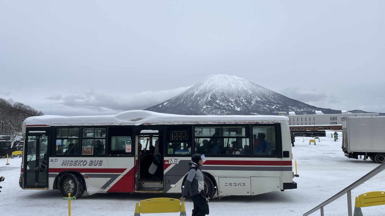 A Niseko shuttle bus with Mt. Yotei in the background
