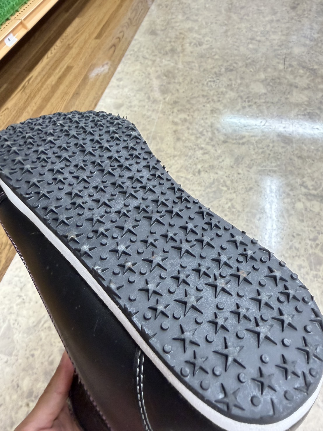 Close-up of a black boot sole with a star-shaped tread pattern